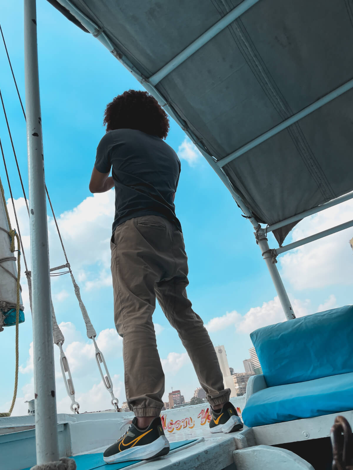 Mido standing on a felucca on the Nile in Cairo