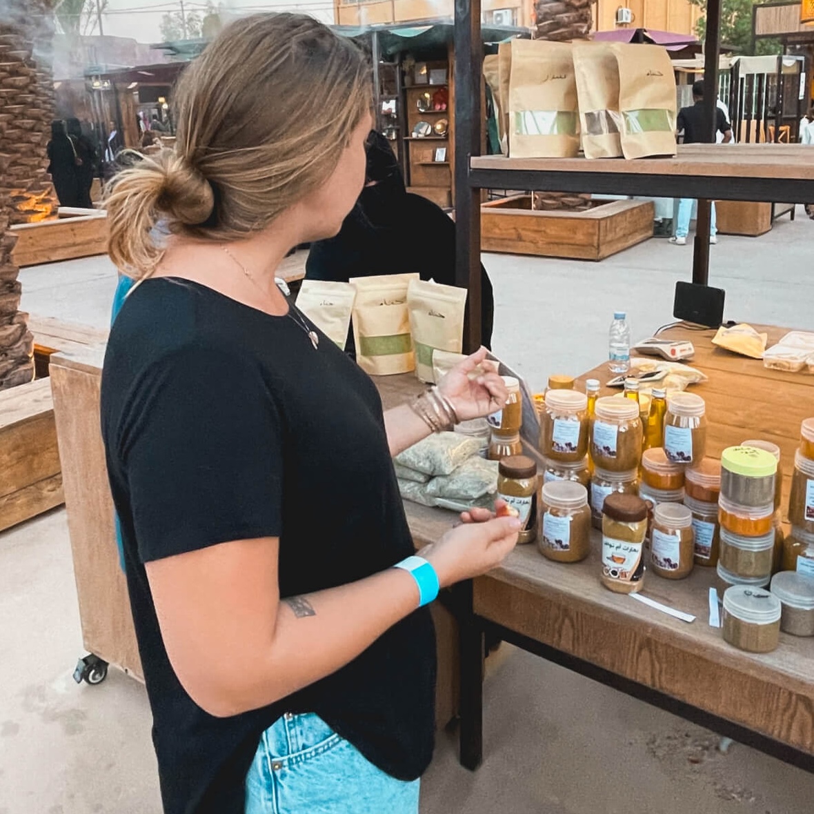 Sidney looking at goods for sale at the AlManshiyah Farmers Martket